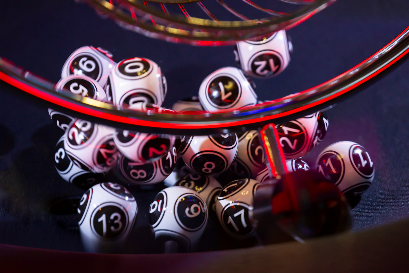 Black and white lottery balls in a bingo machine. Lottery balls in a sphere in motion. Gambling machine and euqipment.