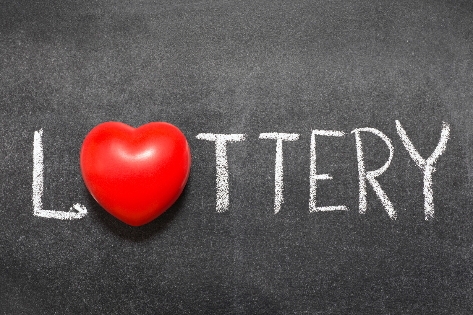 lottery word handwritten on blackboard with heart symbol instead of O