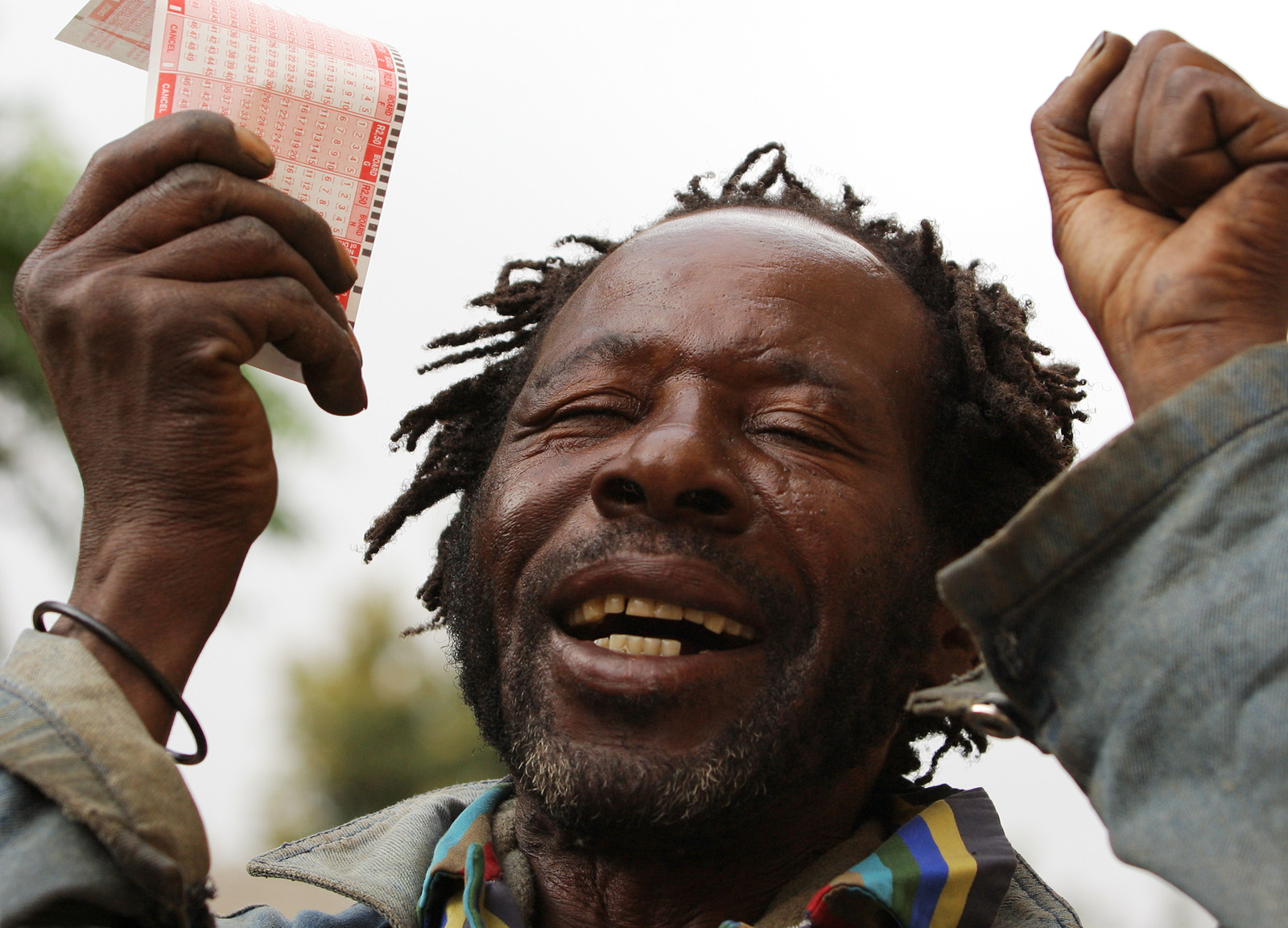 A vagrant celebrating a big financial gain by winning on the lottery.