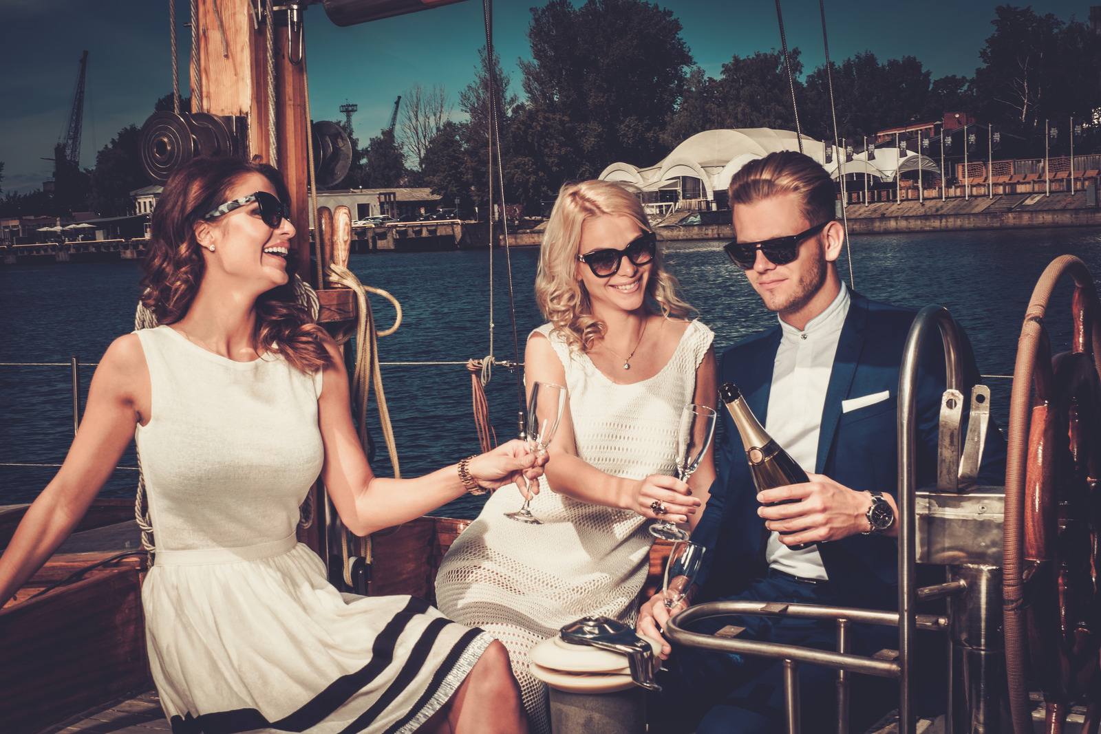 Stylish wealthy friends having fun on a luxury yacht